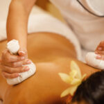 closeup-woman-getting-back-massage-with-detox-herbal-compresses-spa-salon