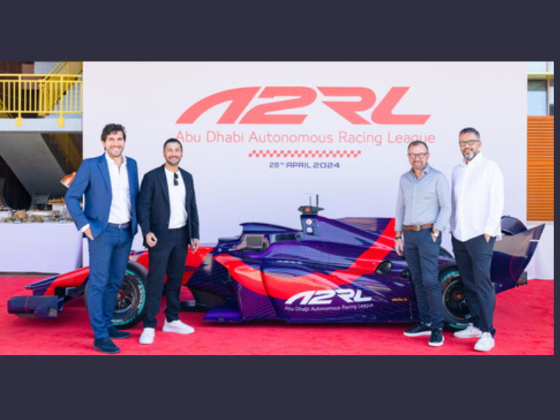 The ASPIRE team took a group photo with the newly unveiled self-driving Super Formula SF23 car in Abu Dhabi (Photo: AETOSWire)