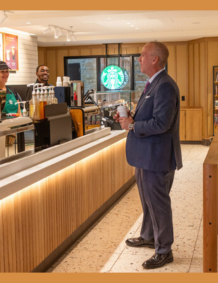 University of Tulsa President Brad R. Carson picks up his order and visits with the staff at Oklahoma's largest Starbucks, which opened on the main floor of McFarlin Library on Nov. 1, 2023.