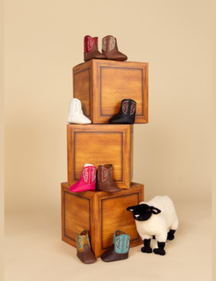 Justin's new infant cowboy boots featuring the Bea in white and Baby Canter in brown, tan, and black shades (Image Courtesy: PRNewswire)