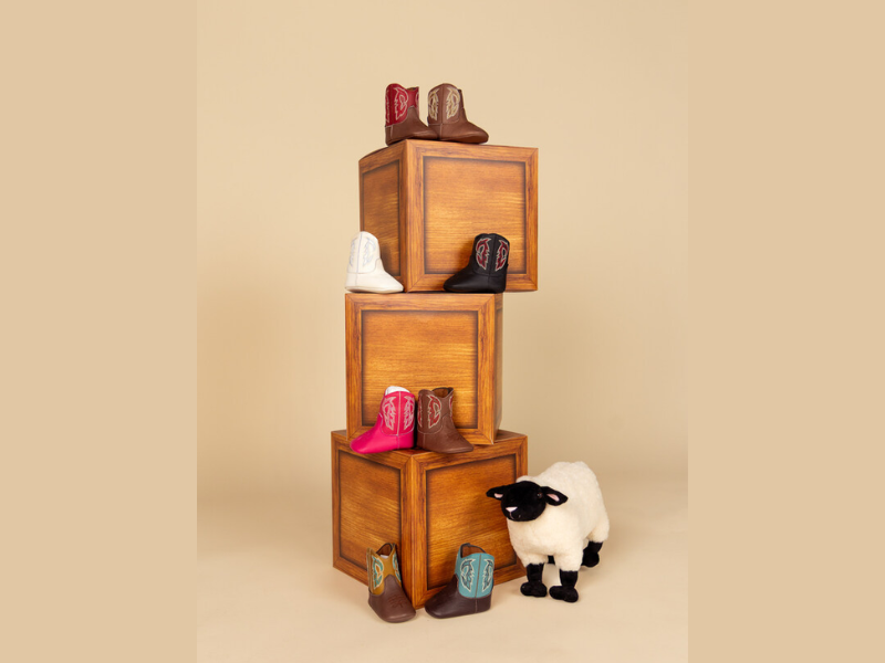 Justin's new infant cowboy boots featuring the Bea in white and Baby Canter in brown, tan, and black shades (Image Courtesy: PRNewswire)