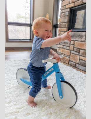 From tummy time to toddling, the Strider Baby Balance Bike is the one toy that supports every stage of a baby's development from 0-18 months. With bumpy letters, numbers, and shapes on the wheels, the bike begins as an adorable tummy time toy that delivers sensory fun in the nursery. As babies get older, the super lightweight walk-with-me design makes it the perfect assisted walking toy (Image Courtesy: PRNewswire)
