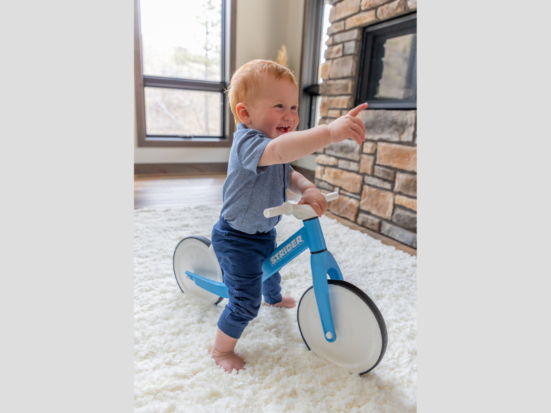 From tummy time to toddling, the Strider Baby Balance Bike is the one toy that supports every stage of a baby's development from 0-18 months. With bumpy letters, numbers, and shapes on the wheels, the bike begins as an adorable tummy time toy that delivers sensory fun in the nursery. As babies get older, the super lightweight walk-with-me design makes it the perfect assisted walking toy (Image Courtesy: PRNewswire)