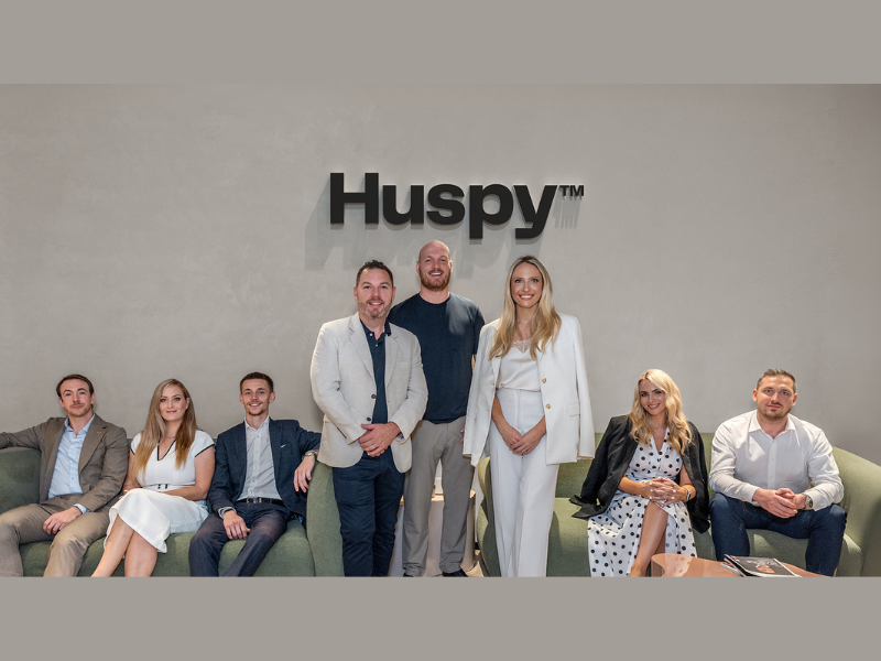 Standing (left to right) Patrick Hayden, Founder, LuxuryX, Mark Castley, CEO of Real Estate, Huspy and Georgia Peacock, with members of the LuxuryX team (Image Courtesy: PRNewswire)